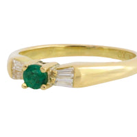 Emerald and baguette diamond ring in 18 carat gold