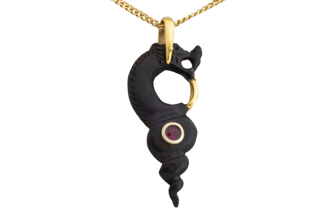 Ebony gold and ruby serpent pendant