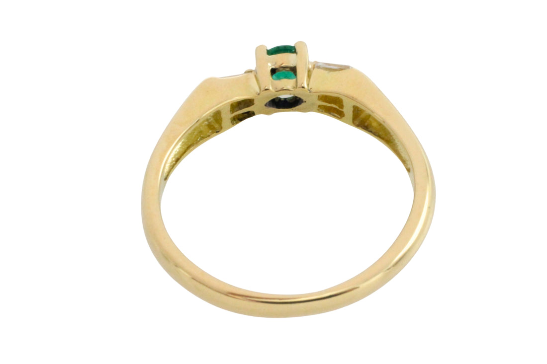 Emerald and baguette diamond ring in 18 carat gold
