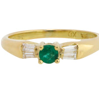 Emerald and baguette diamond ring in 18 carat gold