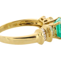 Emerald and baguette cut diamond ring in 18 carat gold