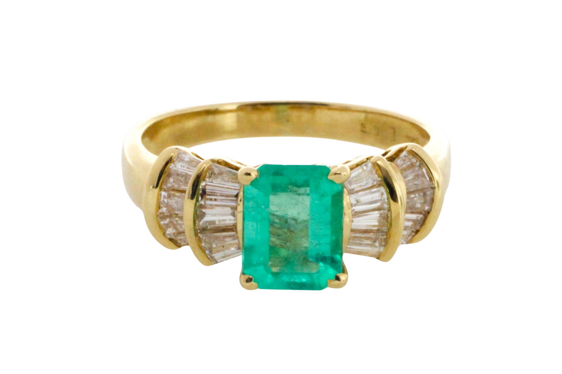 Emerald and baguette cut diamond ring in 18 carat gold