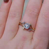 Old cut diamond solitaire ring in white and yellow gold.