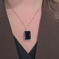 Garnet and diamond pendant in white gold
